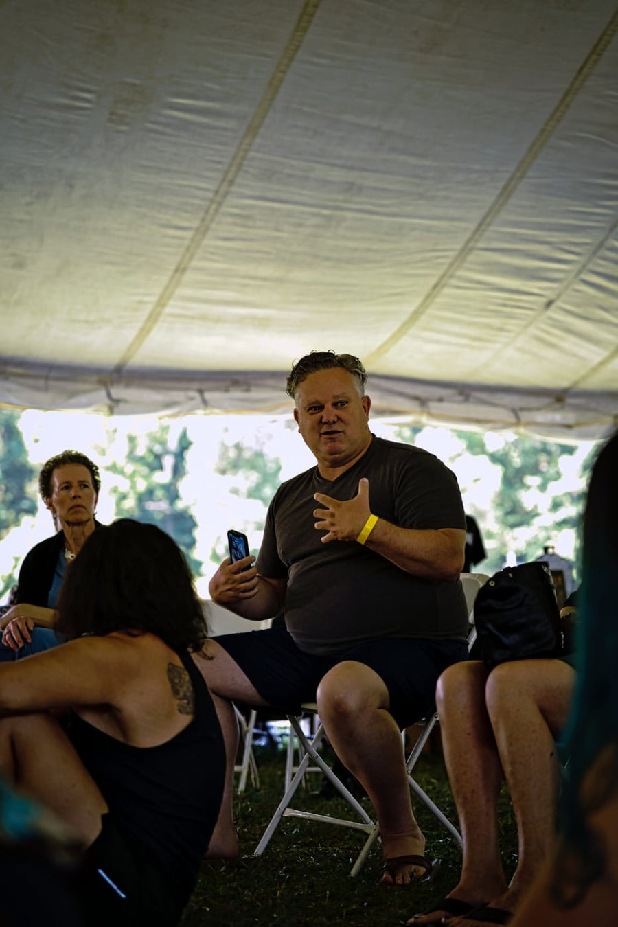 Speaking into the circle under the tent