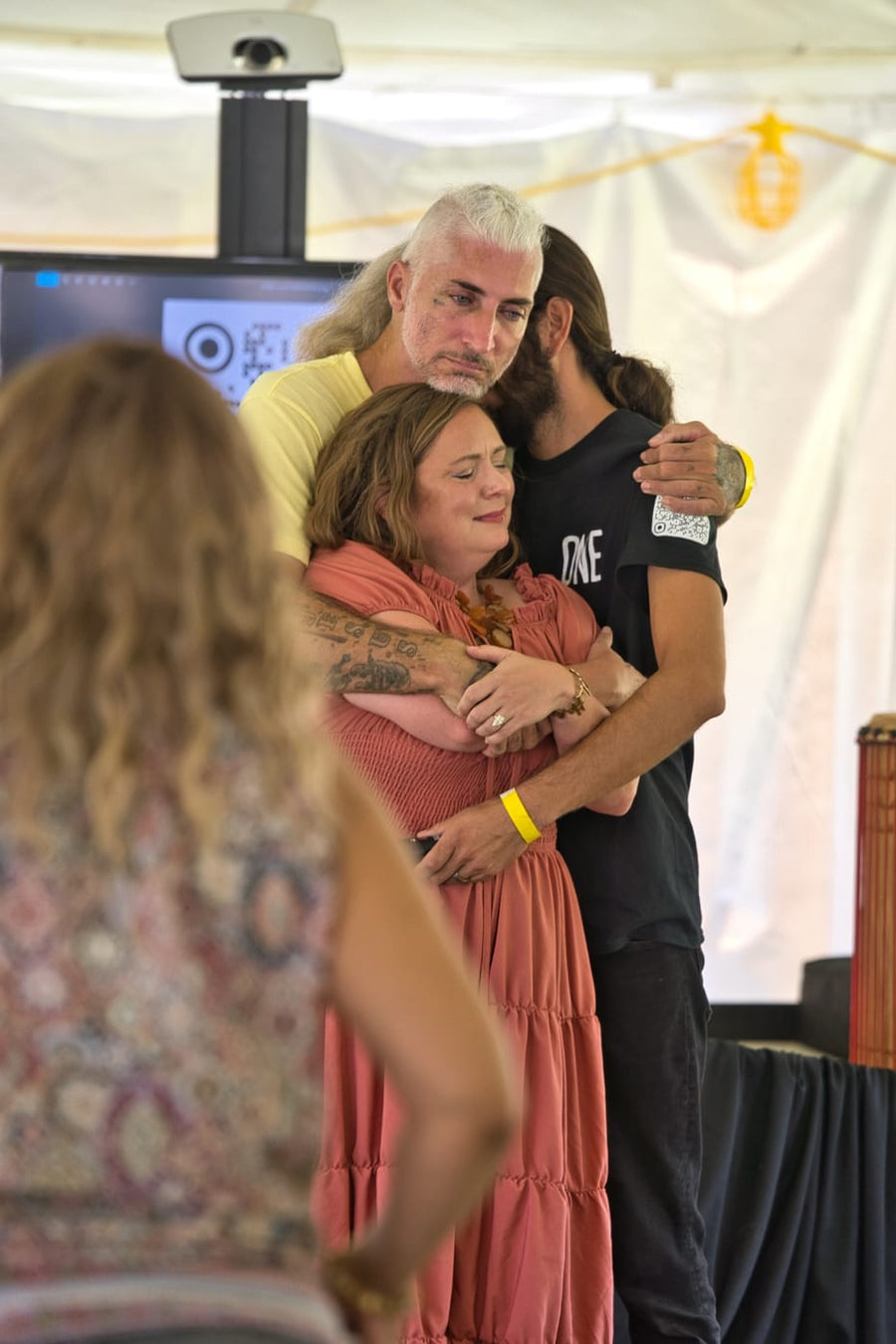 Three held together in an embrace after a testimony