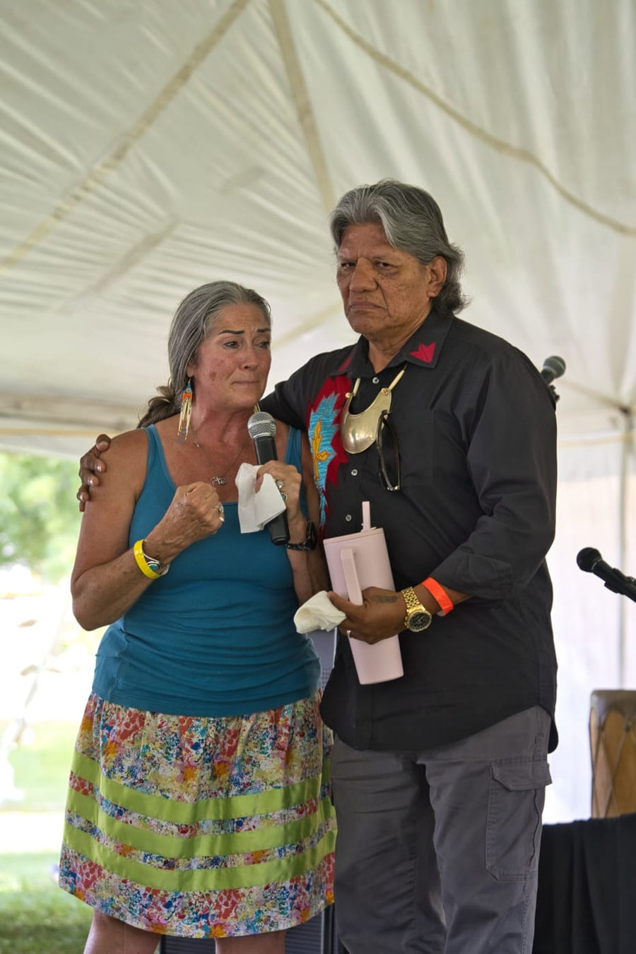 An elder holds her as she finishes